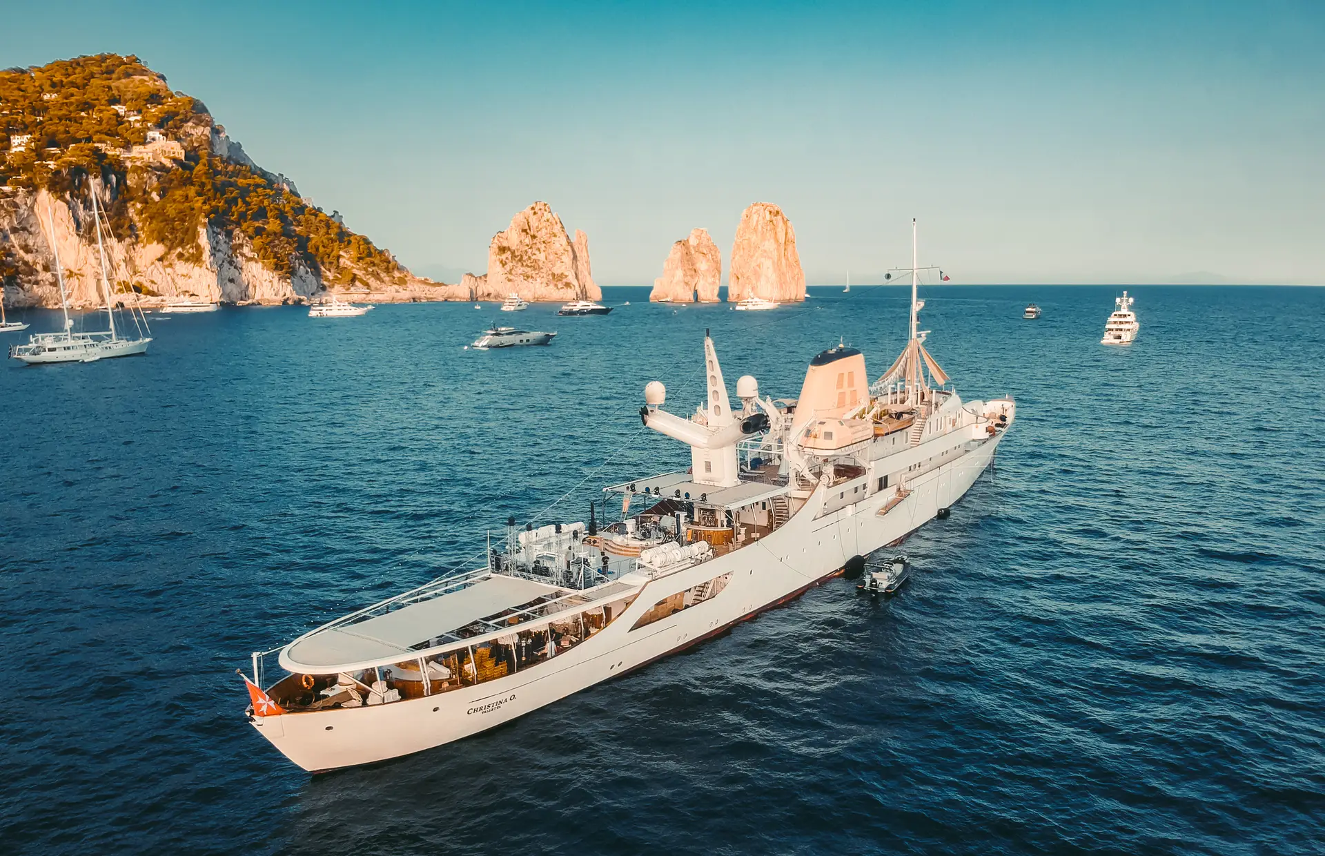 A converted wartime frigate serving as a large private motor yacht at sea